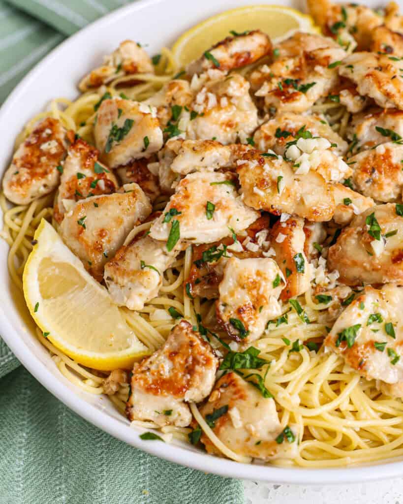 Quick and easy Chicken Scampi is lightly breaded chicken pieces cooked to golden brown perfection and combined with pasta in a lemon garlic butter sauce with freshly grated Parmesan.