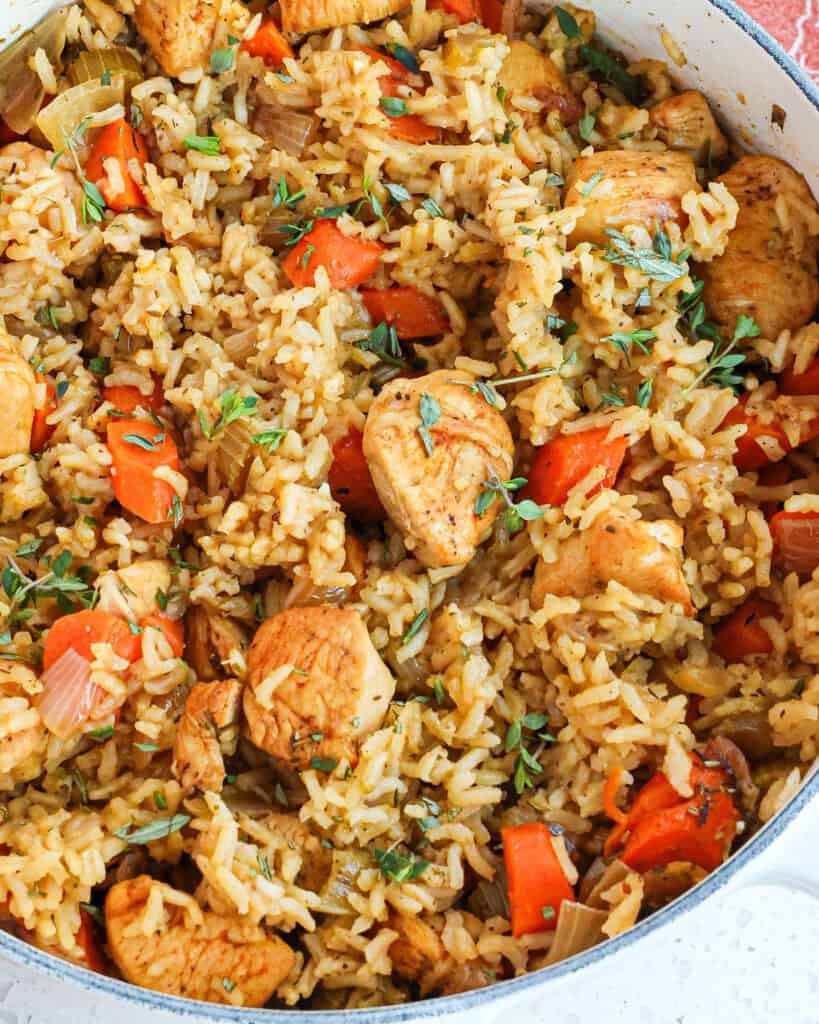This easy one-pot Chicken and Rice Recipe combines bite-size golden brown chicken pieces with onions, celery, carrots, and jasmine rice in a tasty blend of spices.