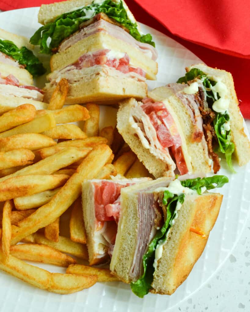 A classic club sandwich served with French fries.