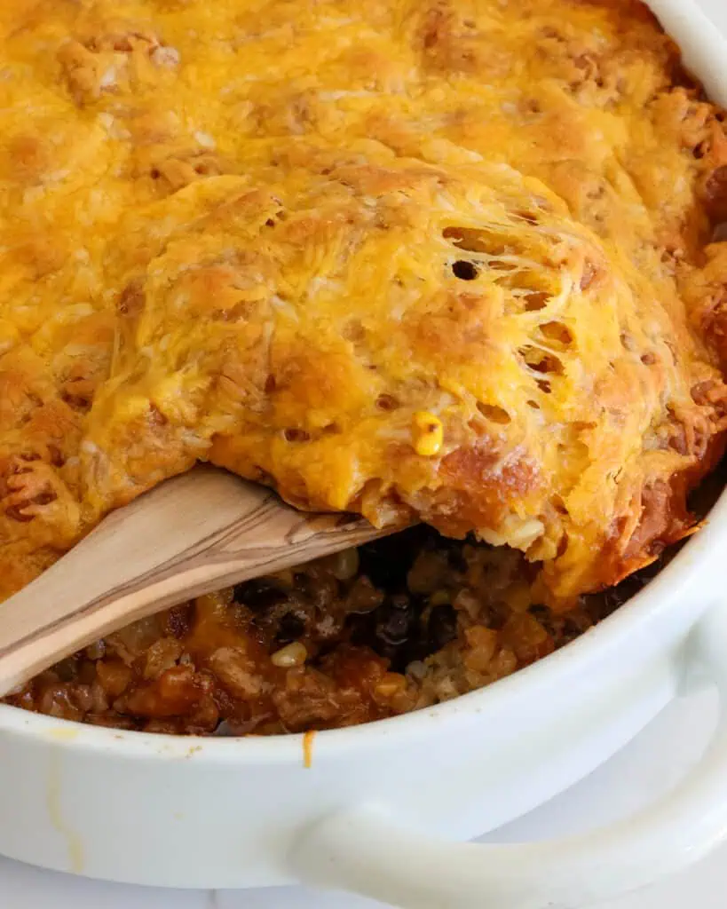 A dish full of cheesy tater tot cowboy casserole. 