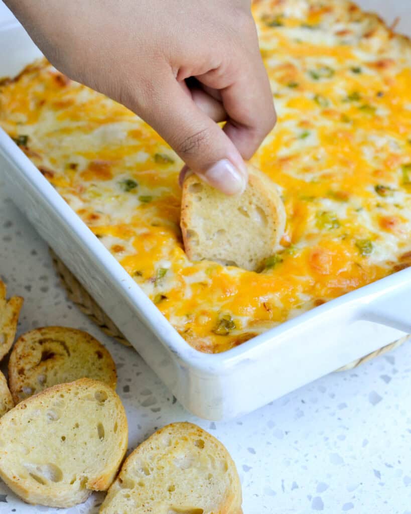 An easy-to-make hot crab dip filled with creamy cheese, cooked lump crab meat, and a perfect blend of spices. All baked to golden brown and served warm. Simple yet elegant enough for Christmas and New Year's Eve.