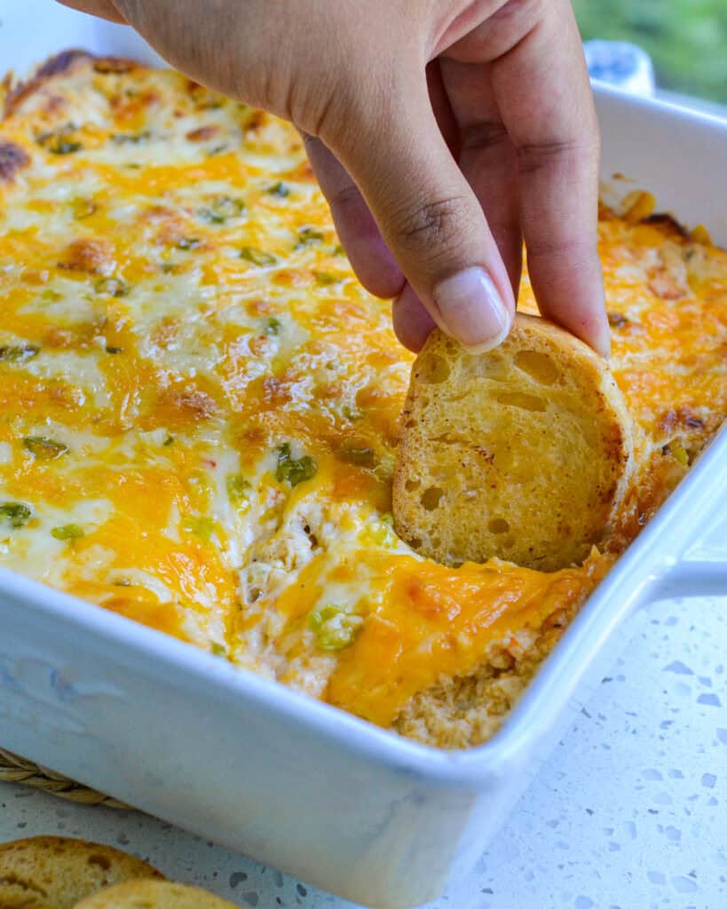 A crisp crostini dipped in hot crab dip.