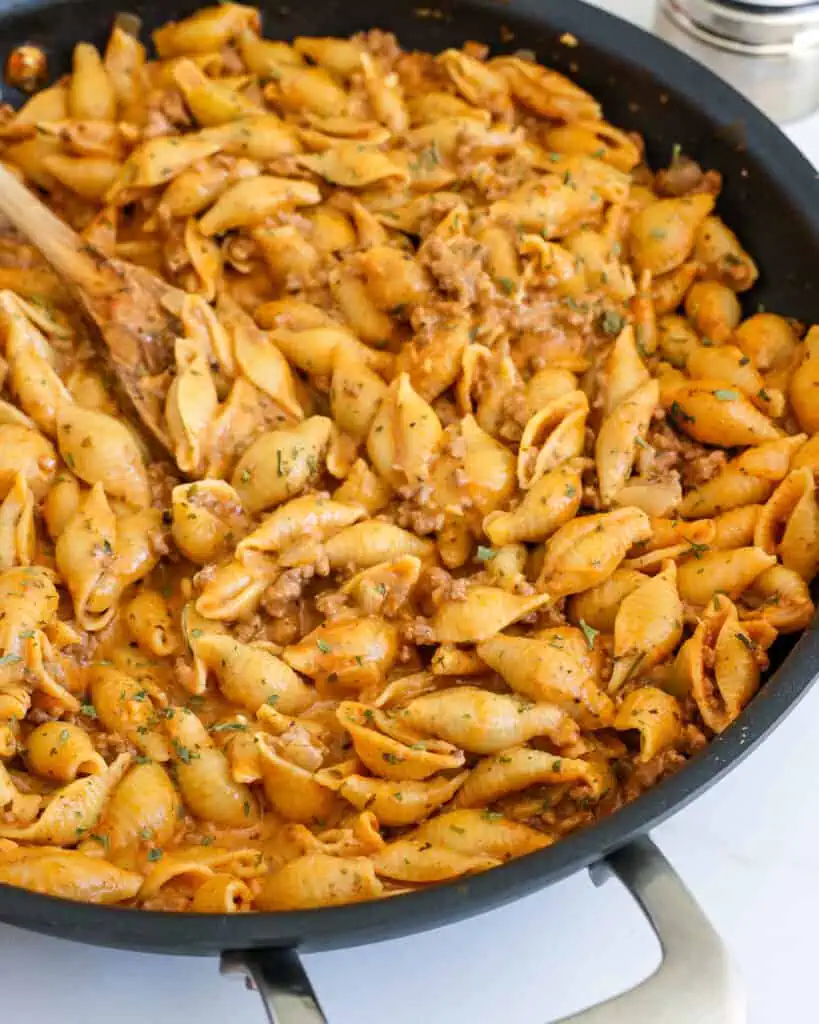 A close up view of creamy beef and shells. 