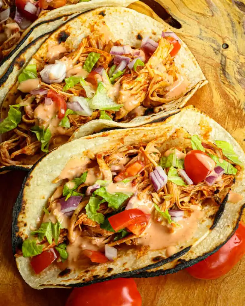 These easy Crock Pot Chicken Tacos cook tender and flavorful with salsa-style tomatoes, onions, and taco seasoning.