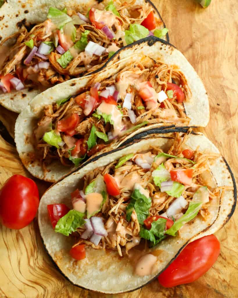 Spoon the tender chicken on to corn or flour tortillas. Customize with all your favorite toppings and drizzle with chipotle ranch.