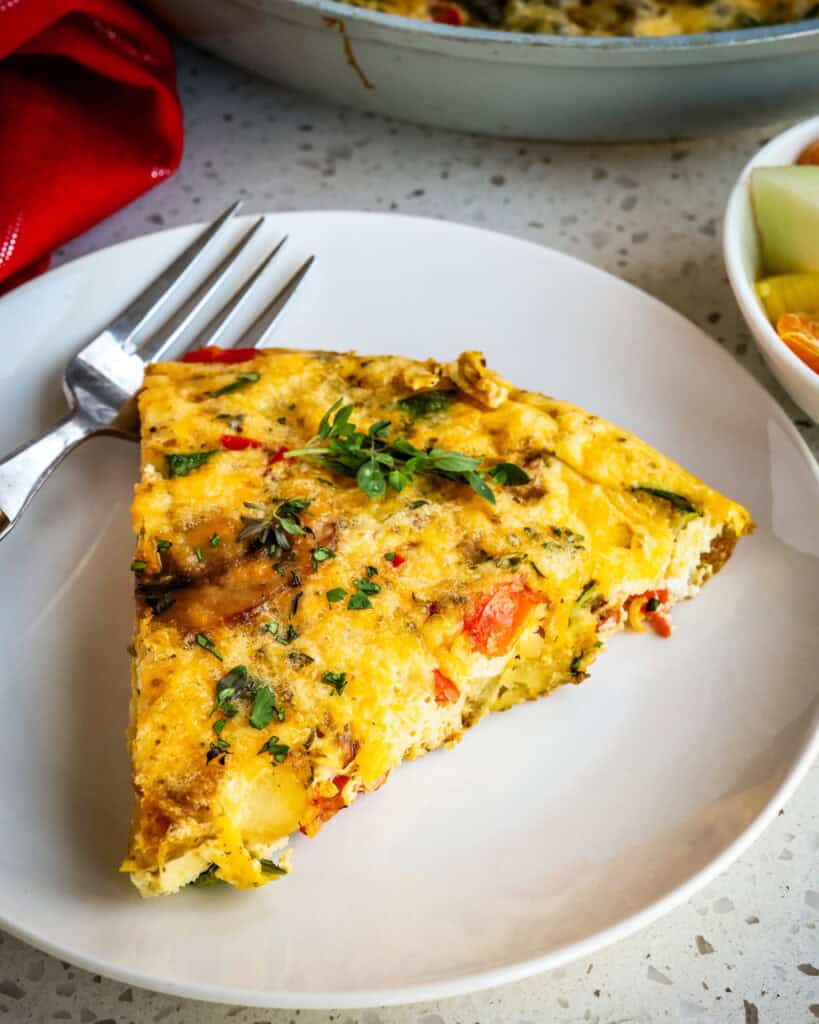 A quick and tasty, easy Egg Frittata made with potatoes, onions, zucchini, mushrooms, red bell pepper, cheddar, and Parmesan Cheese.   Cook up a tasty one today and enjoy all the health benefits of eggs, vegetables, and cheese. 