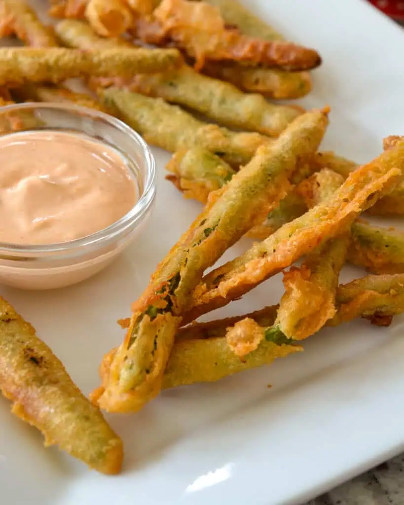 These Crispy Fried Green Beans will hit the spot just right with a slightly spicy crunchy crust on tender fresh green beans.