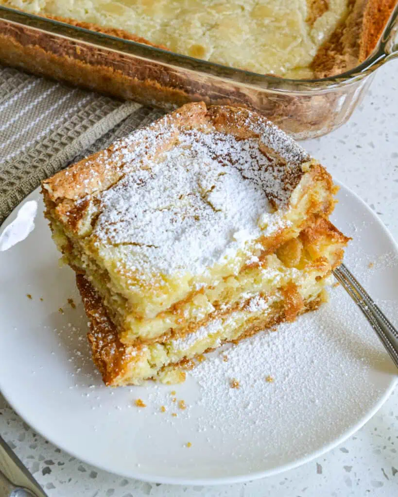 This family friendly Gooey Butter Cake has seven ingredients and takes less than 10 minutes to get in the oven.  It is so popular at potlucks and family reunions that is usually the first dessert gone.  Bake one up for your family today and let them be the judge.