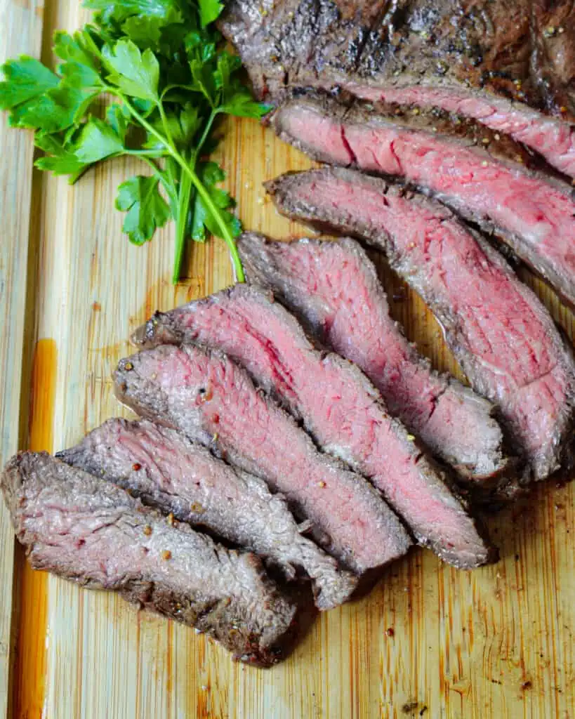 Grilled Flank Steak is a tender beef steak that is marinated in a balsamic vinegar base and seared. It is perfect in fajitas or on a salad with bleu cheese.