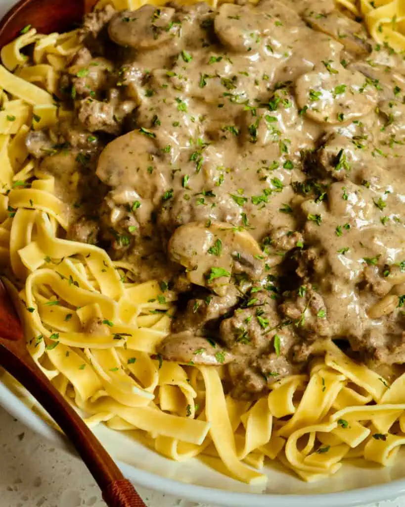 Ground Beef Stroganoff is made with tender ground beef and a creamy mushroom gravy, served over egg noodles.