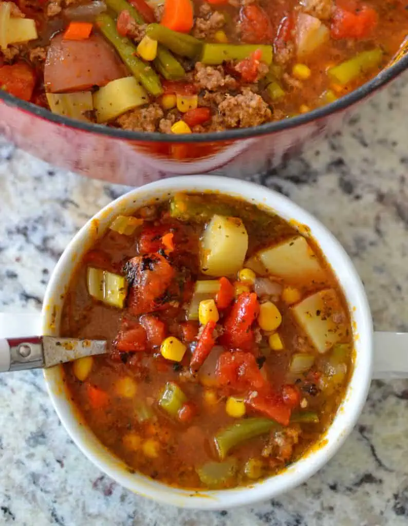 This delicious hamburger soup brings ground beef, onions, celery, carrots, green beans, tomatoes, corn, potatoes, and a perfect blend of spices together in a seasoned vegetable stock. 