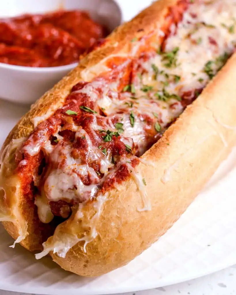 An easy, family-friendly meatball sub recipe made with fresh meatballs, marinara, mozzarella, and Italian spices, all baked to melted perfection and served warm.  They are ideal for movie nights, sleepovers, game day, and pool parties.