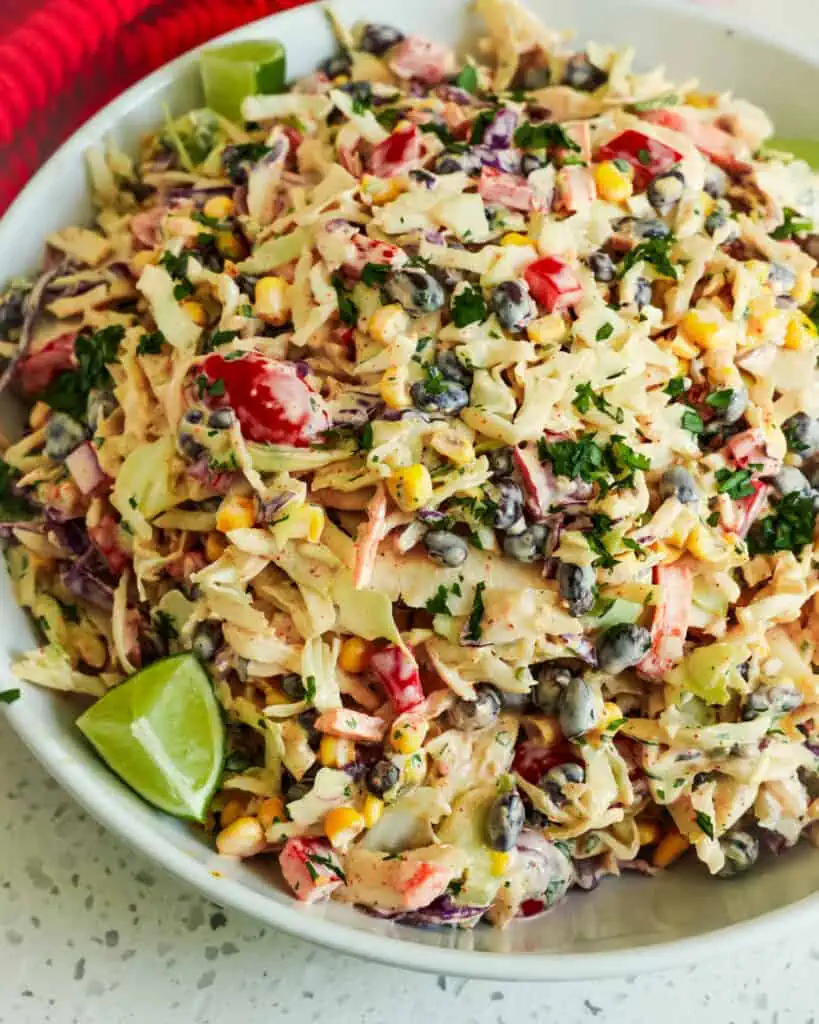 This Easy Mexican Cabbage Slaw can be prepped in about twenty minutes, making it the perfect side dish for picnics, potlucks, summer cookouts, and pool parties.