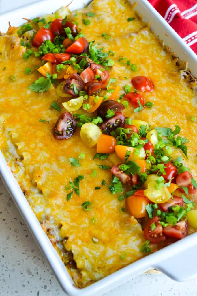 This family friendly Mexican Lasagna with layers of melted cheese, taco seasoned ground beef, and creamy refried beans is sure to please.