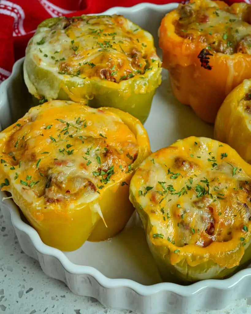 These fun Mexican Stuffed Peppers are filled with seasoned ground beef, onions, garlic, fire roasted tomatoes, and rice, 