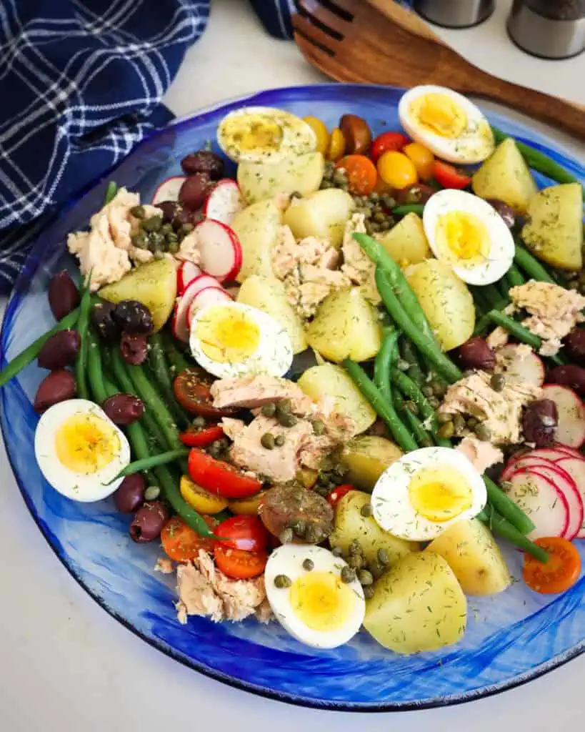 The Nicoise salad is not tossed but elegantly arranged on a platter or serving plate, making it as pretty as it is delicious. 