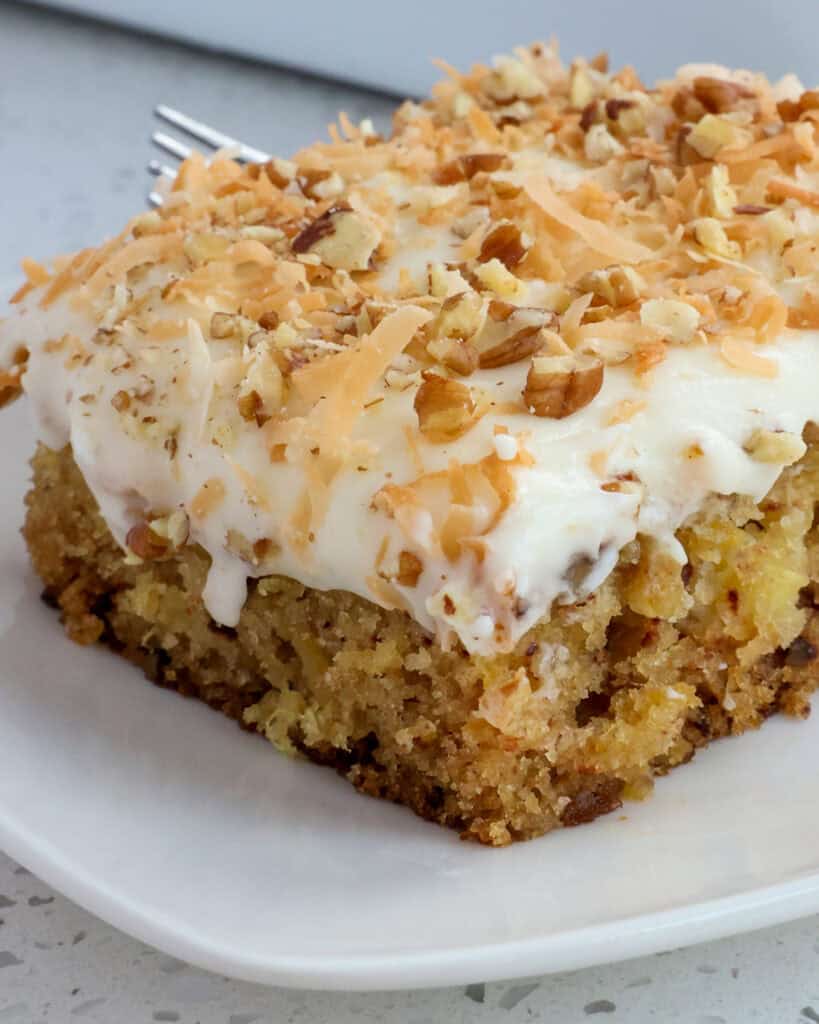 This Pineapple Cake Recipe with Cream Cheese Frosting is a pineapple lover's dream come true, with flavors of pineapple, coconut, and pecan.