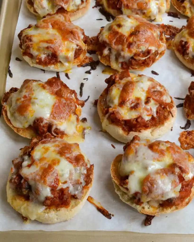 English muffins topped with browned hamburger, onions, pepperoni, marinara, and mozzarella cheese. 