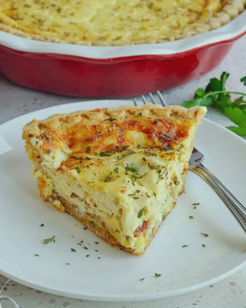 This creamy Quiche Lorraine is flavor packed with crisp bacon, sauteed onions and slightly salty nutty gruyere cheese.  For a quick and almost effortless quiche start with a ready made frozen pie crust.
