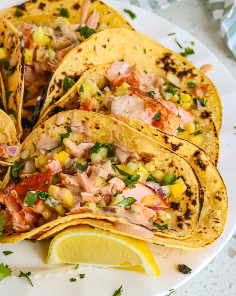 Serve the salmon tacos promptly so the corn tortillas do not become soggy. 