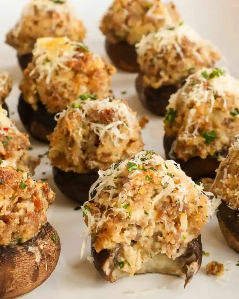 Baked sausage stuffed mushrooms on a serving platter. 