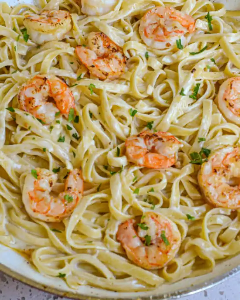 Scrumptious and easy Shrimp Alfredo is pan sautéed shrimp and fettuccine pasta in a creamy garlic Parmesan cheese sauce. 
