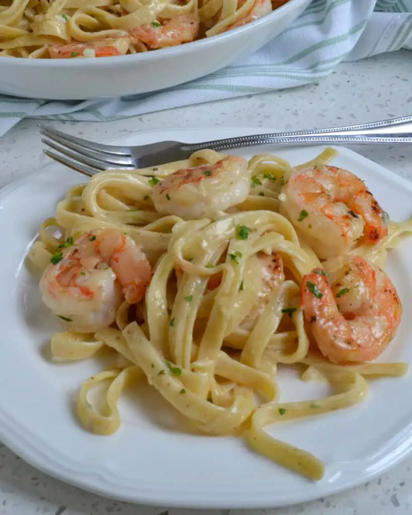 A quick and easy delicious Shrimp Fettuccine Alfredo recipe with tender shrimp cooked in butter and tossed with fettuccine noodles in a rich, creamy Alfredo sauce.