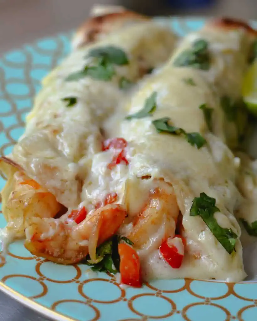 Creamy Shrimp Enchiladas brings together fresh shrimp, shallots, red bell pepper, and garlic, all wrapped up in a creamy Monterrey Jack cheese sauce. 