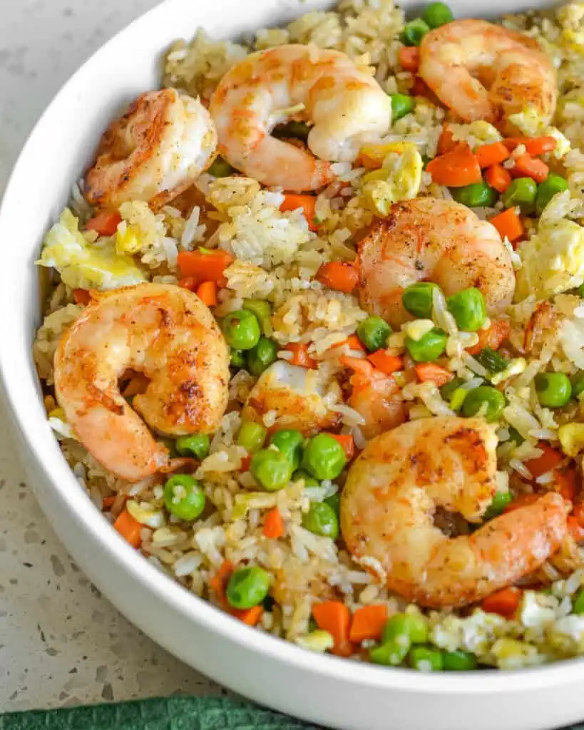 This shrimp fried rice recipe comes together in less than thirty minutes and tastes much better than takeout. 