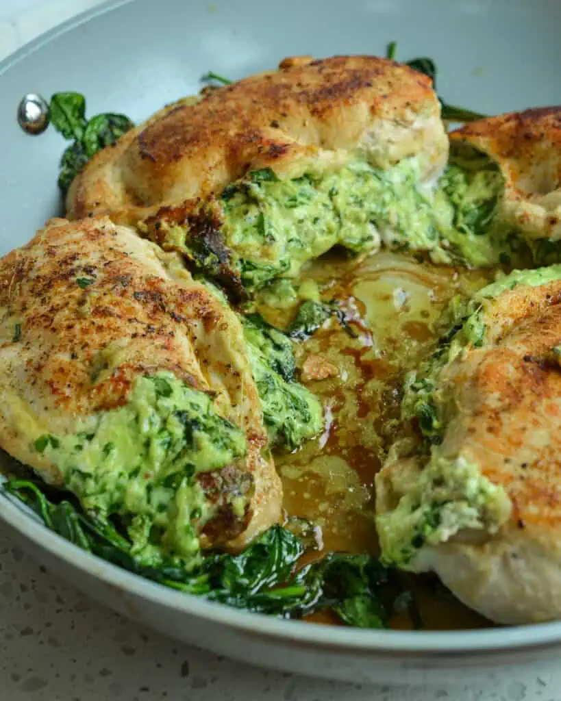 Elegant enough for company yet easy enough for a weeknight these Spinach Stuffed Chicken breasts are plump full of fresh spinach, herb cream cheese, mozzarella, Parmesan Cheese and garlic all cooked to golden brown perfection.