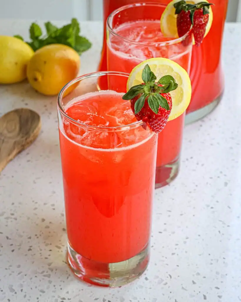 With a handful of ingredients, a little advanced preparation, and five minutes you can have a delicious cold strawberry lemonade thirst quencher for those hot summer days!!