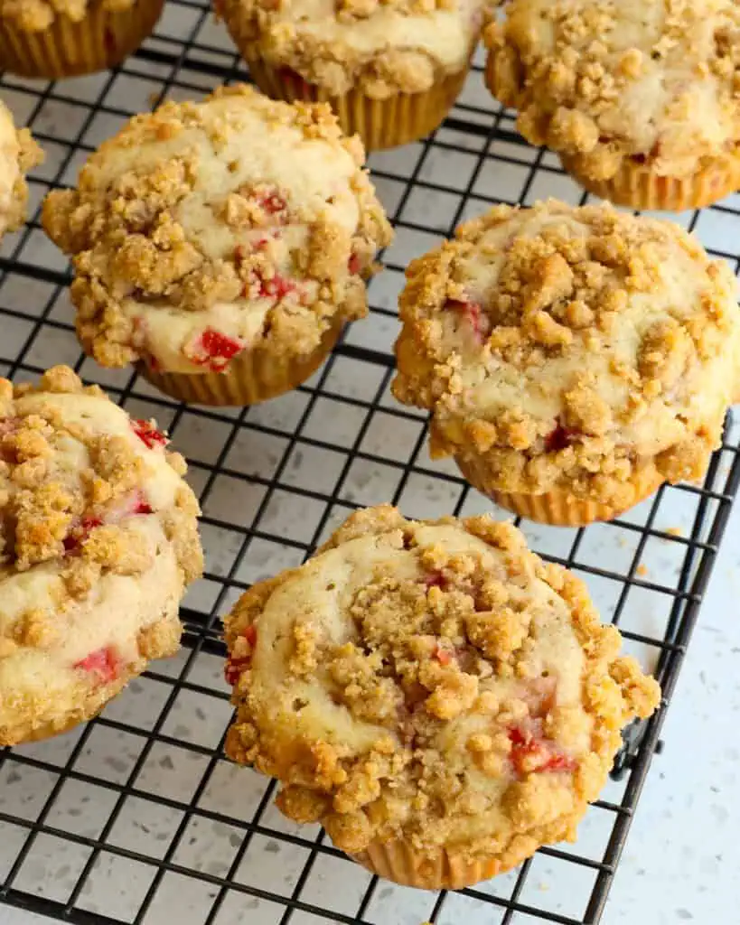 Delicious bakery style Strawberry Muffins made with fresh berries and a quick and easy buttery crumb streusel topping.  Enjoy these treats for breakfast or dessert with a hot pot of fresh coffee.  