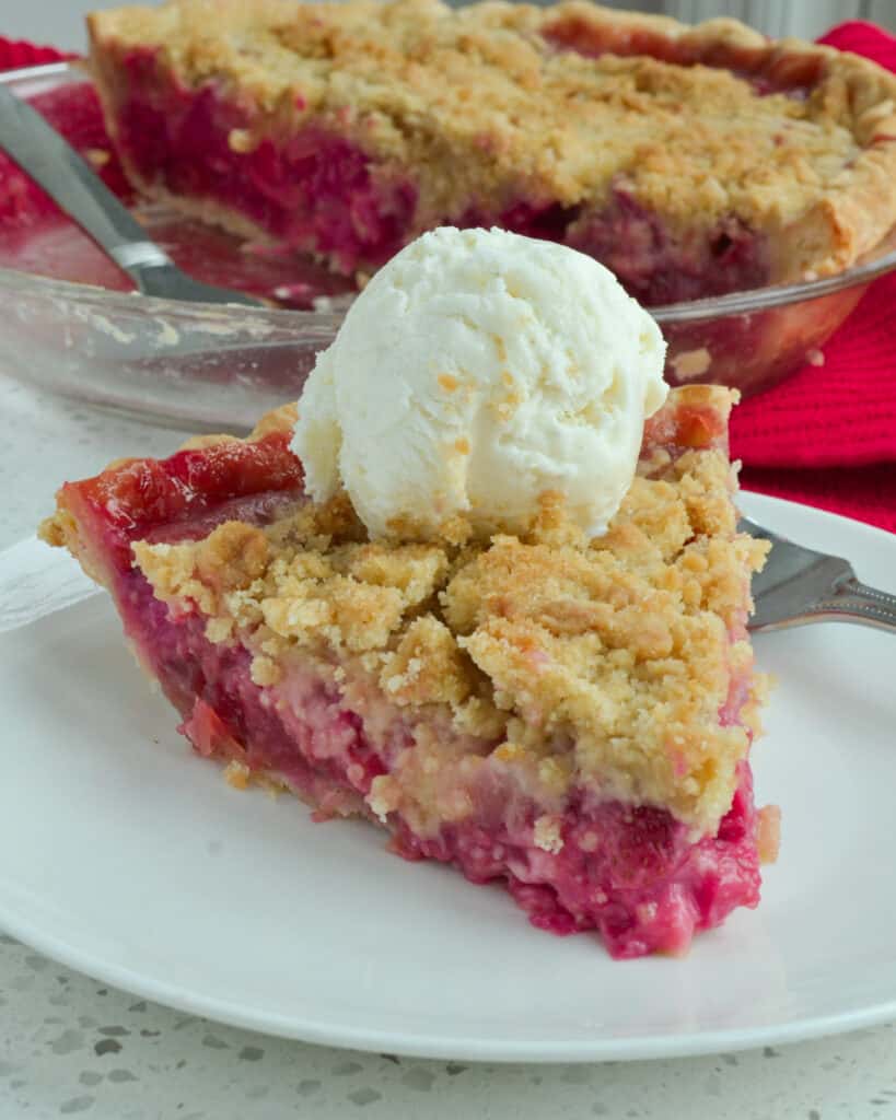 This Strawberry Rhubarb Pie is all the rage with the flavor of fresh sweetened strawberries and rhubarb tucked in a homemade crust and topped with a simple four-ingredient streusel crumb topping.