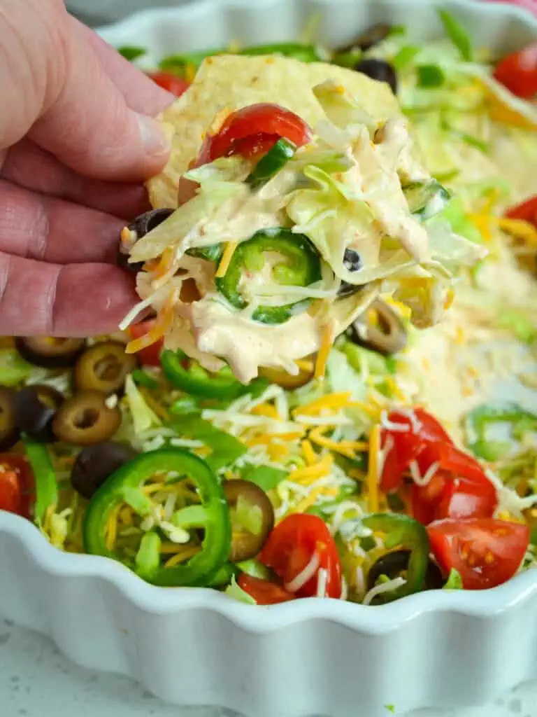 This fun, quick, and easy layer Taco Dip comes together in less than 10 minutes and is always a hit at parties, potlucks, and family reunions.