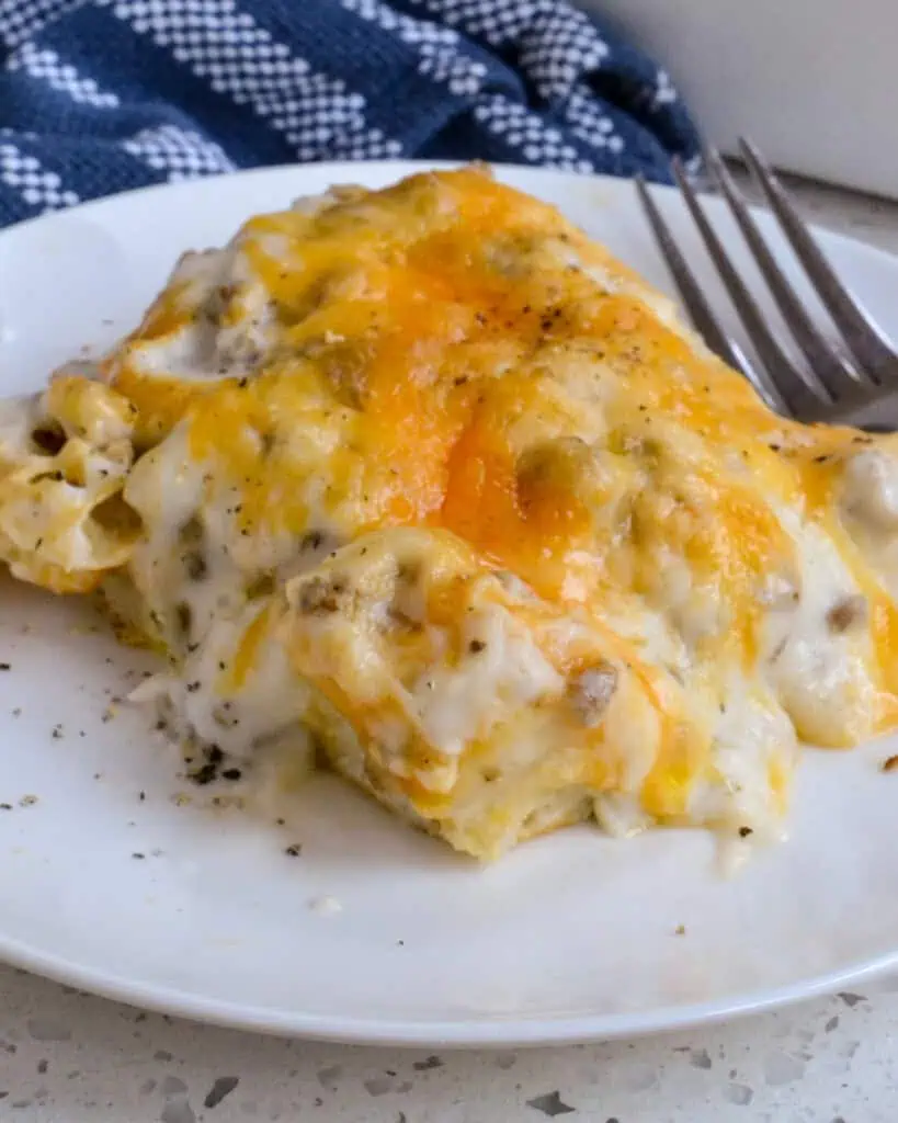 Biscuits and Gravy Casserole combines fluffy biscuits, breakfast sausage, eggs, Colby cheese, and white sausage gravy.