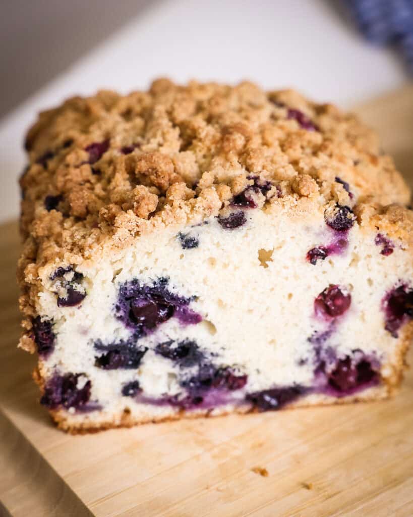 The inside of a loaf of blueberry bread sliced in half. 