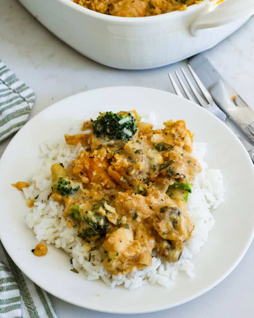 Chicken Divan over rice on a small individual plate. 