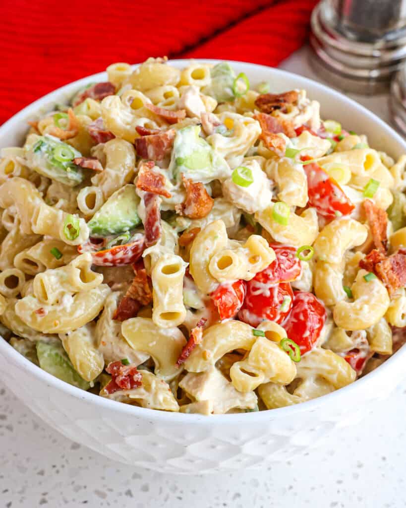 A quick and easy cold Pasta Salad made with already cooked chicken, crispy smoked bacon, tomatoes, and creamy avocadoes, all in a lightly sweetened garlic mustard mayonnaise-based dressing.