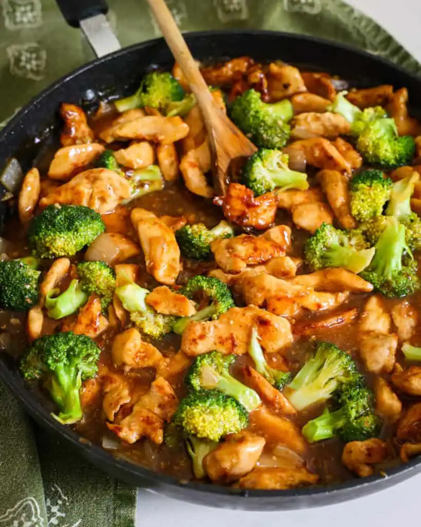 Stir Fried Chicken and Broccoli in a honey ginger stir fry sauce in a skillet. 