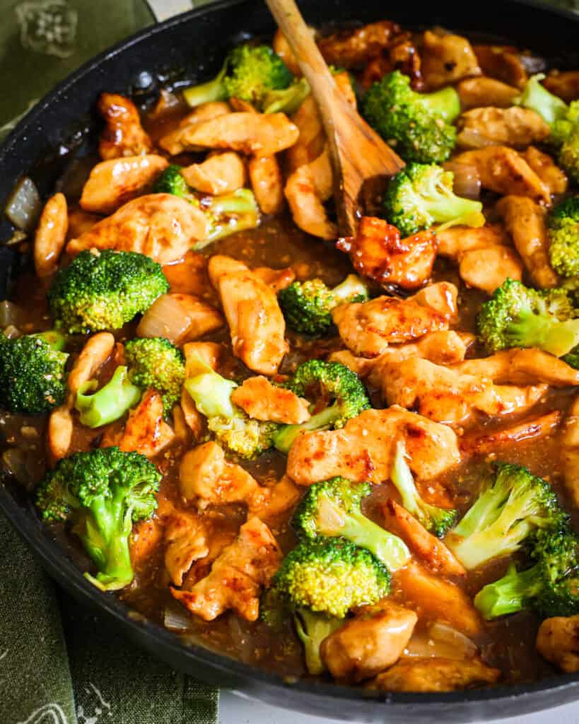 This easy Chicken and Broccoli Stir Fry combines crisp stir-fried golden chicken breast pieces with broccoli and onions in a sweet and spicy ginger stir fry sauce.