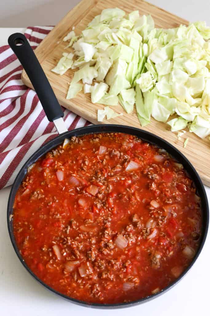 Cook the ground beef, onion, and garlic in a large skillet on the stovetop. Add the spices, brown sugar, crushed tomatoes, beef broth, and rice. Season with salt and freshly ground black pepper to taste.