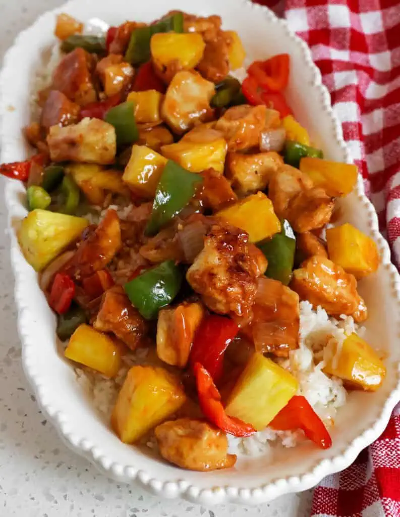 A platter full of sweet and sour chicken