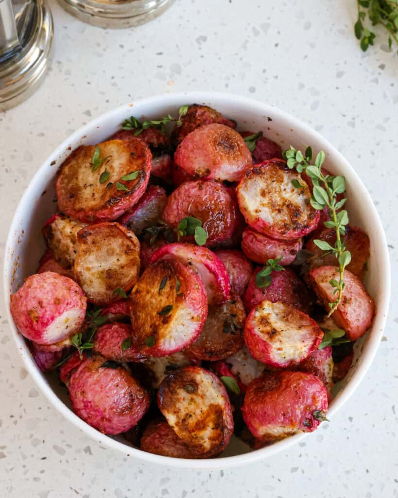 A bowl full of roasted radishes. 