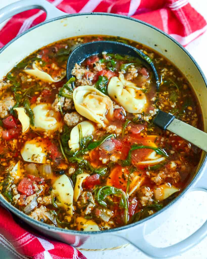 A dutch oven full of sausage and cheese tortellini soup.