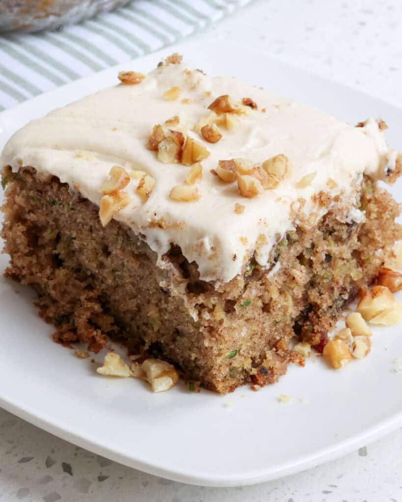 A piece of zucchini cake with cream cheese frosting.