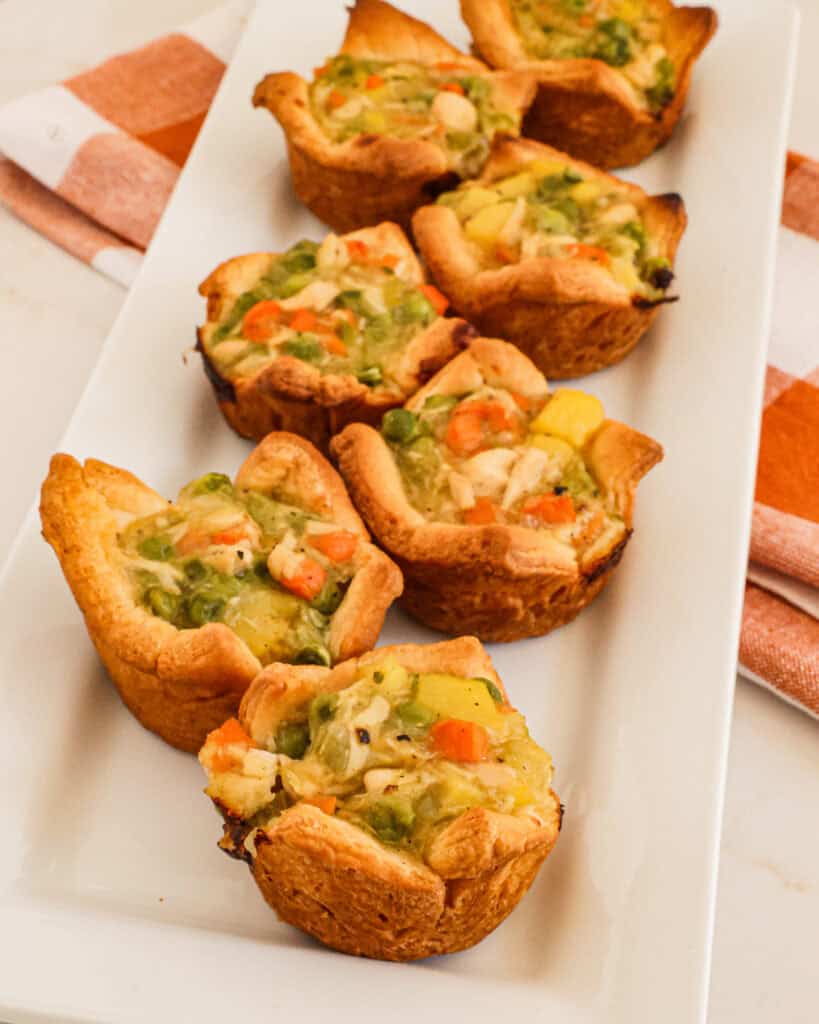 Mini chicken pot pies on a serving platter.
