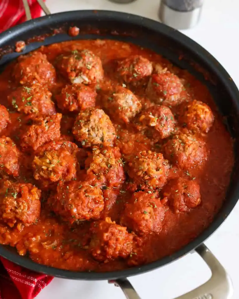 Simmer until the meatballs and rice are tender.