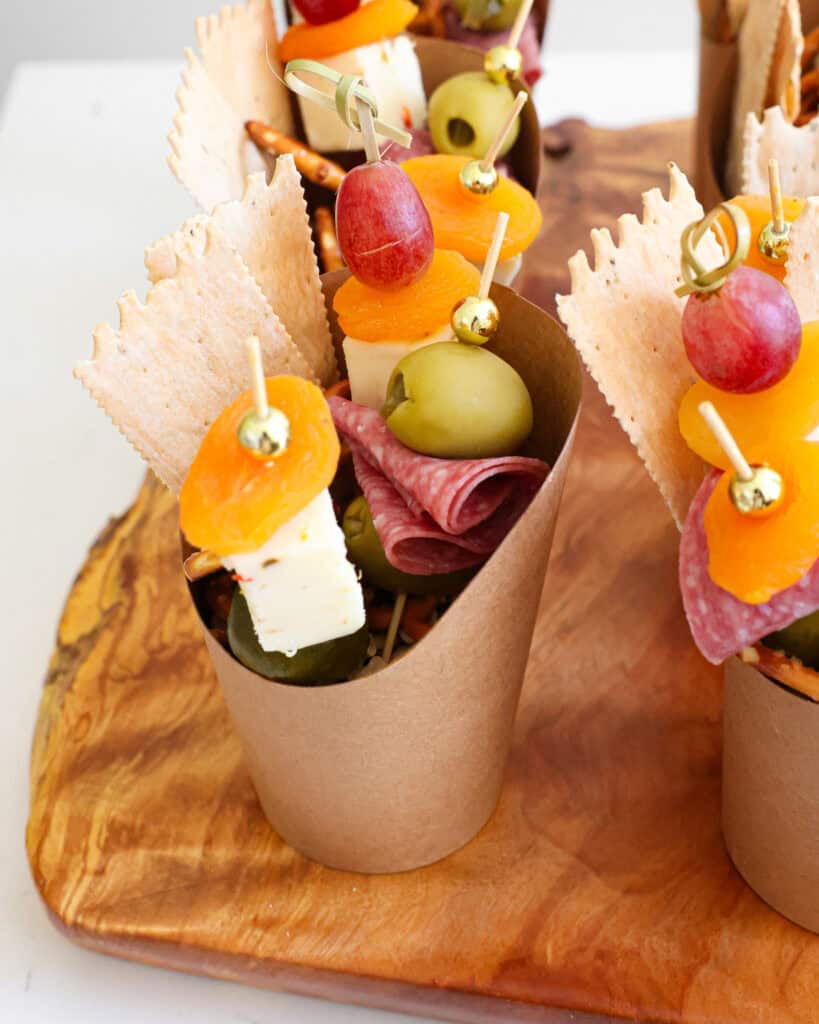 Charcuterie cups on a serving board. 
