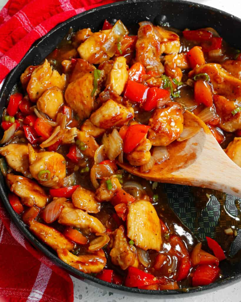 Black Pepper Chicken combines stir-fried chicken breasts, onions, and red bell pepper seasoned with garlic and ginger in a sweet and savory black pepper sauce.