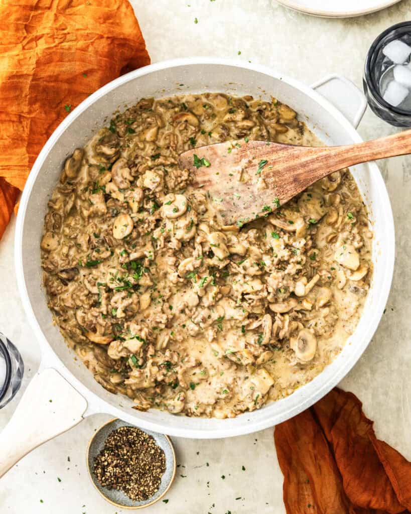 An overhead view of a skillet full of ground beef stroganoff.